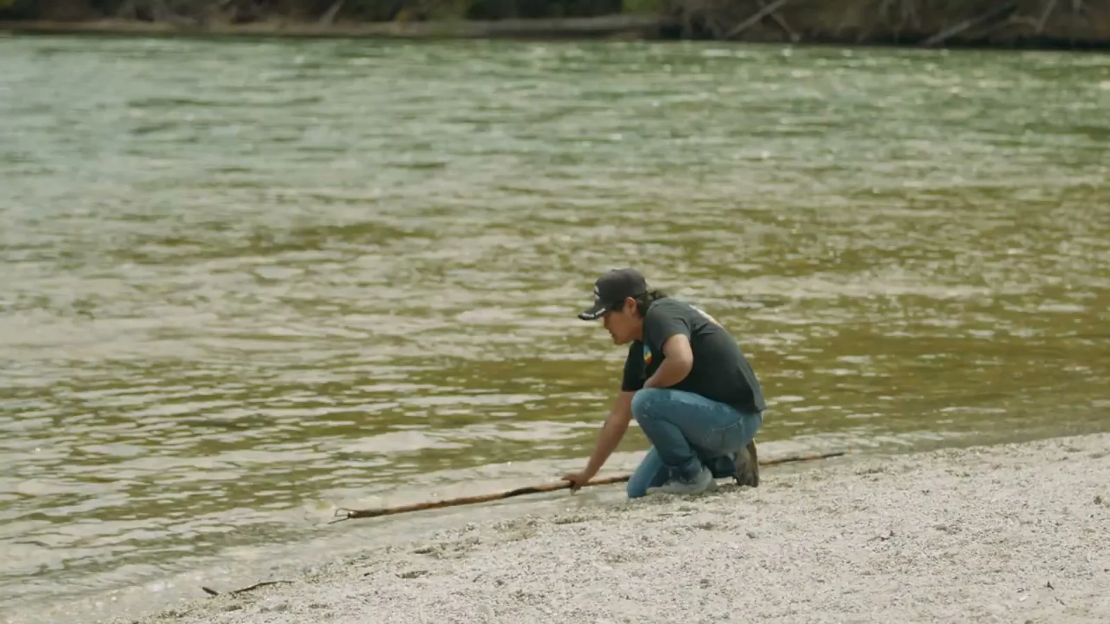 Laureen Felix demonstrating Splatsin traditional fishing practices beside the Lower Shuswap River.