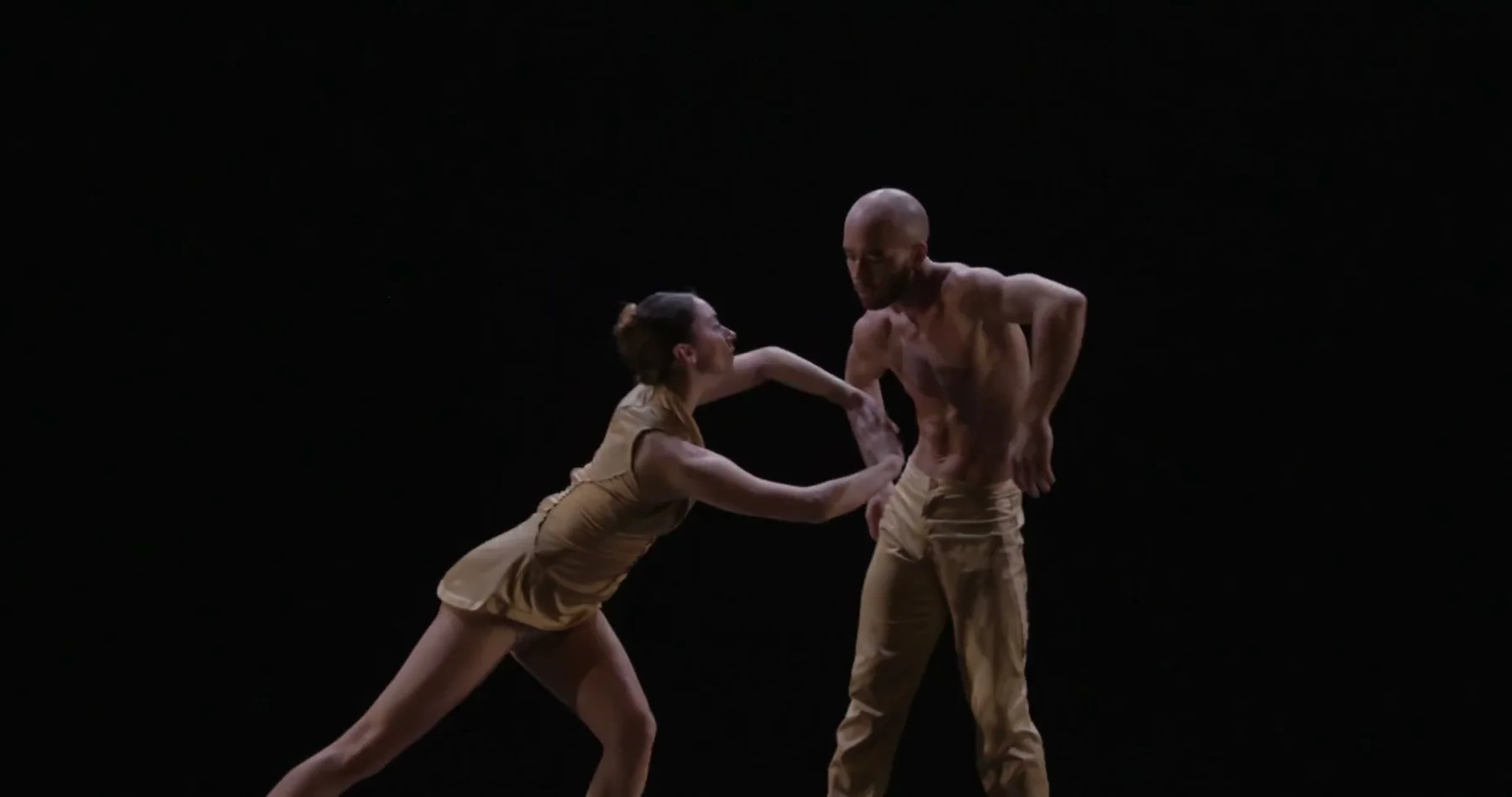Two Ballet Kelowna dancers meet in a standing duet.