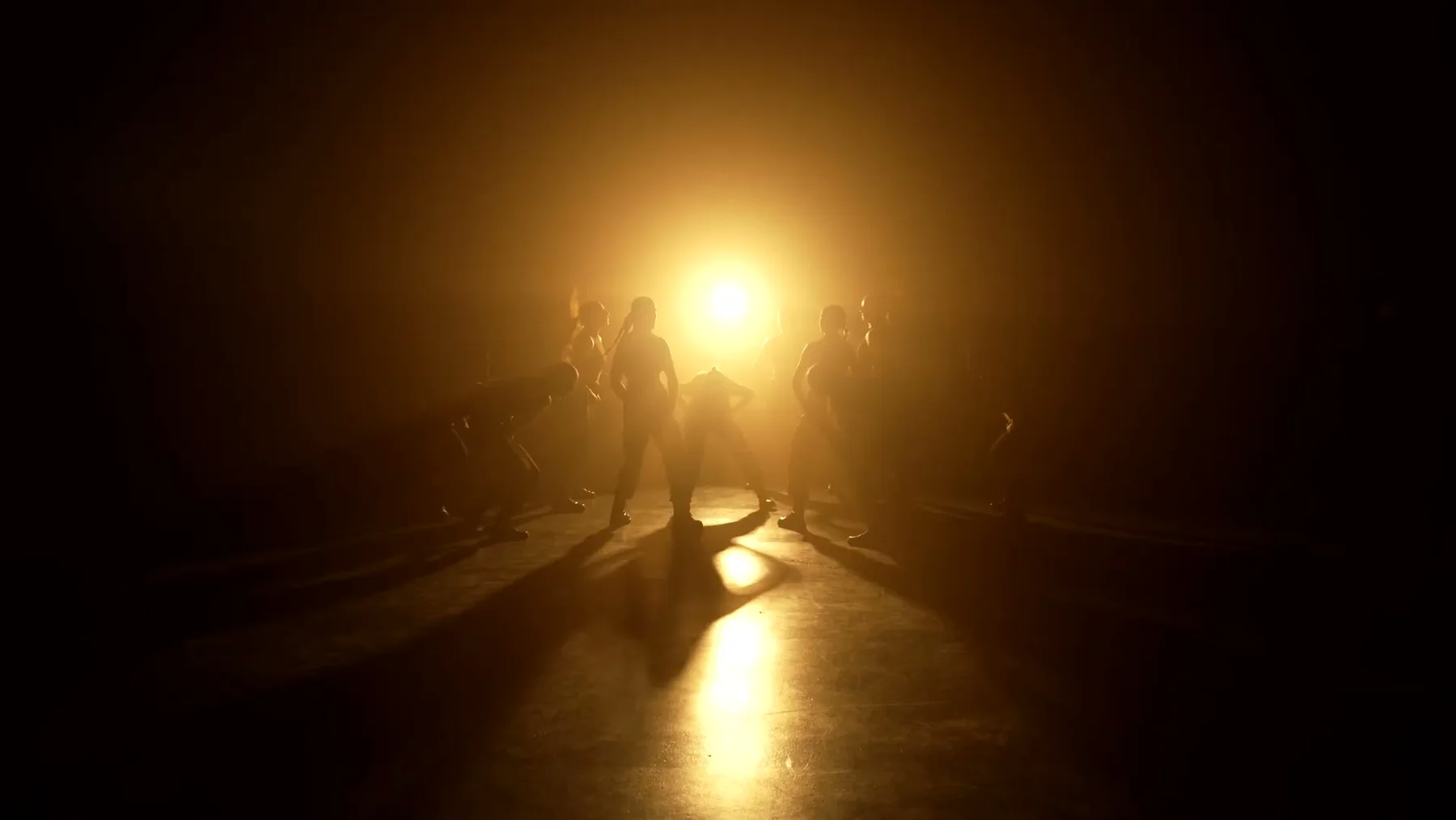 Sockeye 2023 ensemble in silhouette before a single amber stage light.