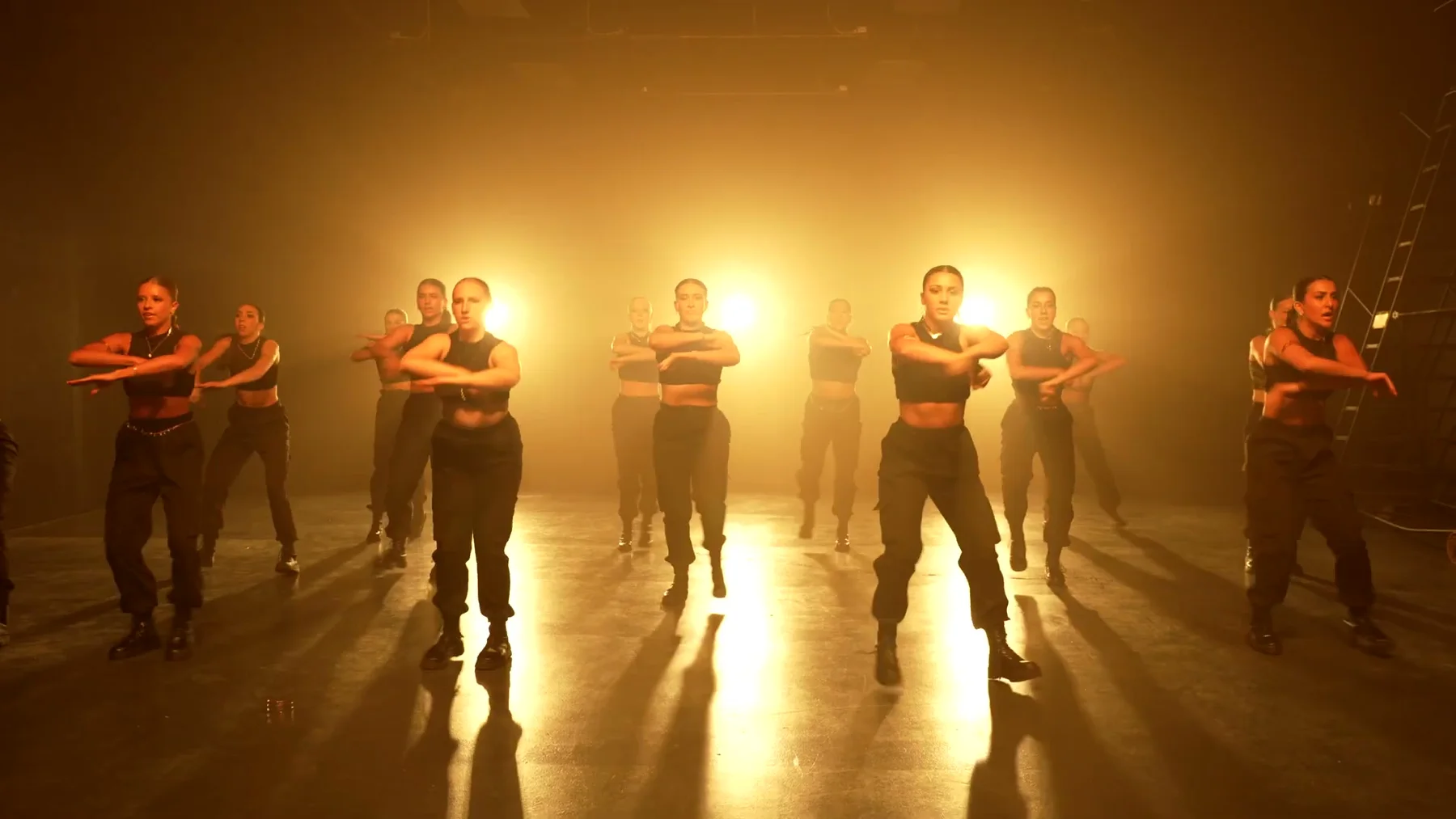 Sockeye 2023 ensemble stands in staggered rows under amber stage light.