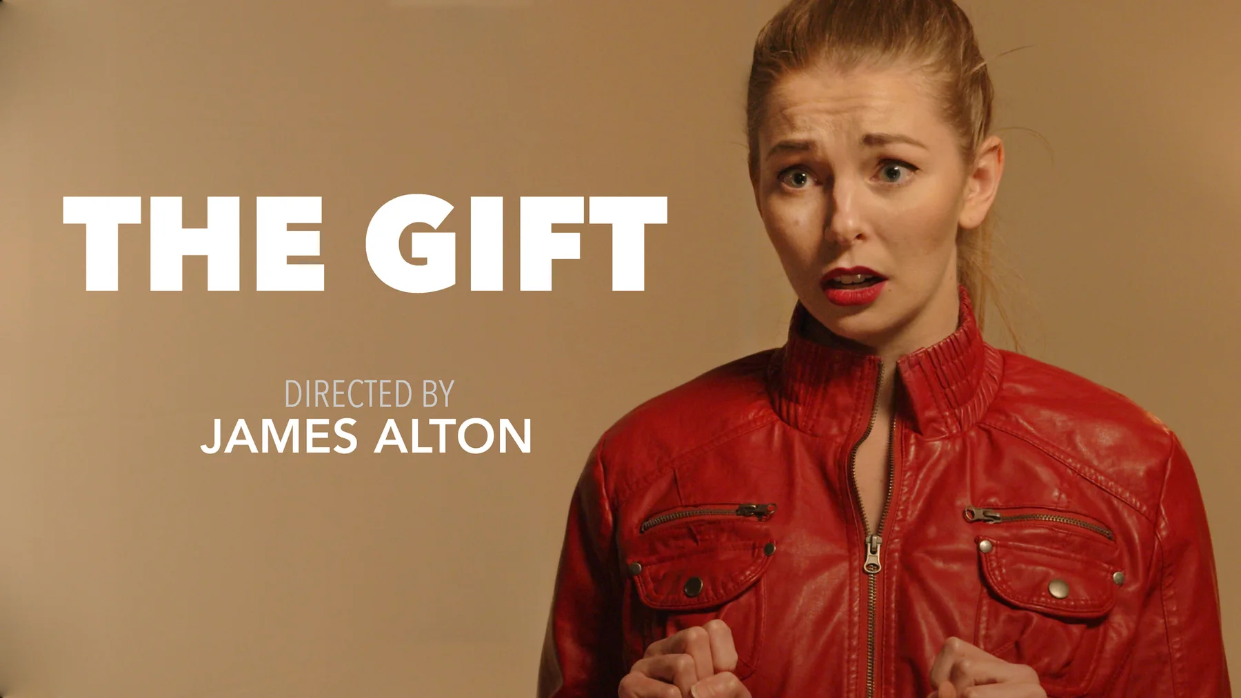 Poster frame for The Gift showing an actor in a red jacket beside the title and James Alton director credit.
