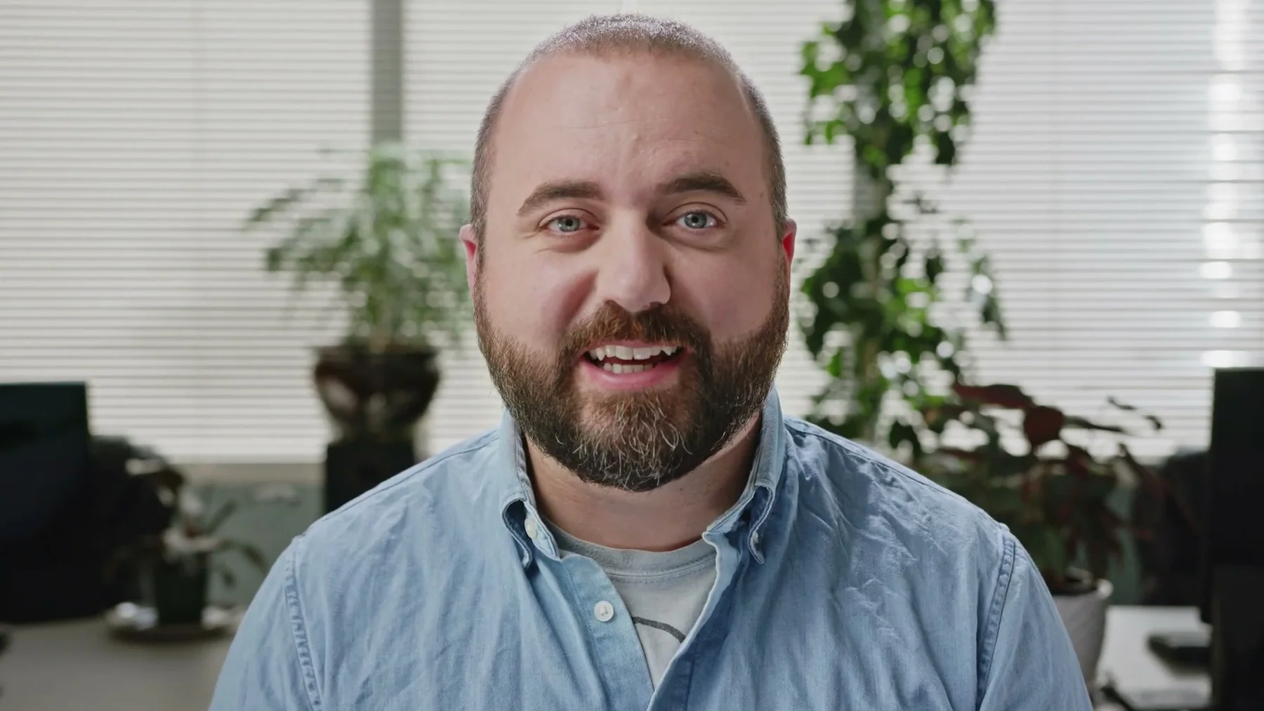A bearded Gneiss Stuff team member speaks from a bright office.