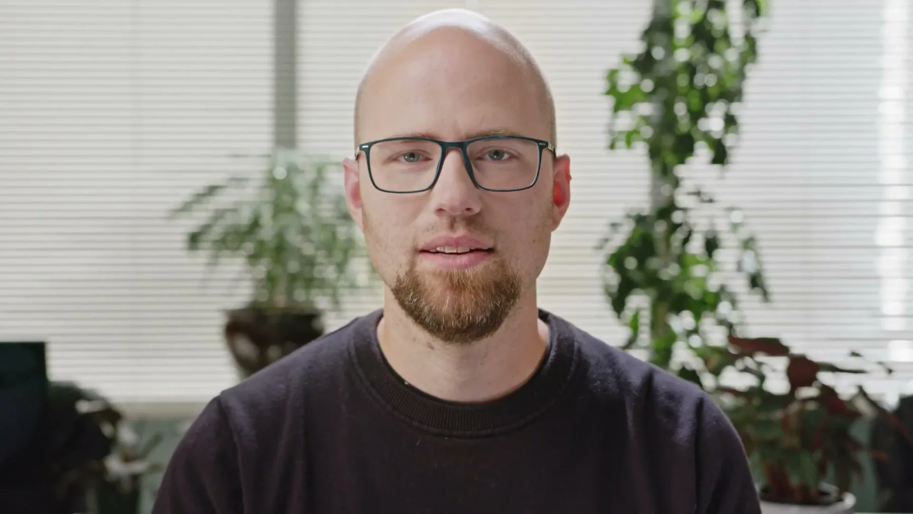 A Gneiss Stuff team member wearing glasses speaks from the office.